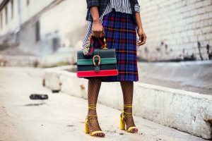 A woman is holding a high fashion handbag - Dato Darren Yaw