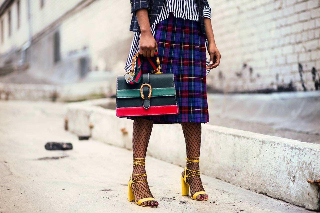 A woman is holding a high fashion handbag - Dato Darren Yaw